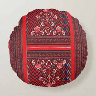 Een rood-zwart schilderij met een rood hart erop rond kussen