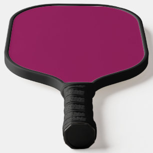 Een roze achtergrond met een witte rand pickleball paddle