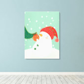 Een sneeuwman die een ornament aan een boom hangt canvas afdruk (Insitu (Houten vloer))