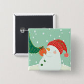 Een sneeuwman die een versiering aan een boom hang vierkante button 5,1 cm (Voorkant /achterkant)
