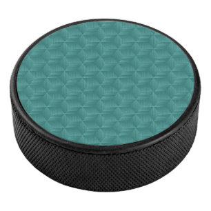Een turquoise geometrisch patroon siert de bovenka hockey puck