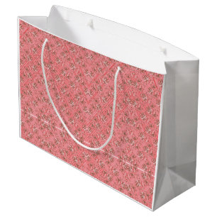 Een vloerkleed met een rood en roze motief heeft e groot cadeauzakje