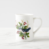 een zangvogel in een bessen struik met de scriptbo porselein kop (Rechts)