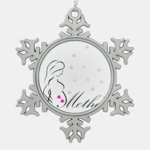 Een zwangere moeder met een miniatuur roze harten tin sneeuwvlok ornament