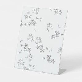 Een zwart-wit foto van sneeuwvlokken reclamebord met voetstuk