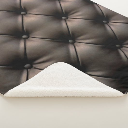 Een zwarte lederen kussenachtergrond, vanaf een au sherpa deken (3/4)