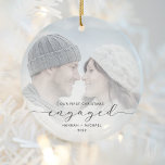 Eerste Kerstmis Aangepast Foto Grijs Manuscript Keramisch Ornament<br><div class="desc">Herinneer je verloving met dit mooie, moderne keepdoesie ornament. De tekst van de houtskool grijs staat "Onze eerste kerst bezet", met het woord "betrokken" in elegant script met swashes voor en na. Vervang het afbeelding van de steekproef met uw favoriete foto, en voeg uw namen en het jaar toe. Een...</div>