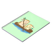 Egel-koppel dat op een houten boot vaart notitieboek (Linkerzijde)