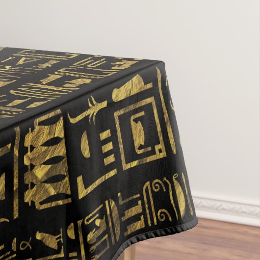 Egyptische hiërogliefen  goud in zwart op zwart tafelkleed (Voorbeeld)