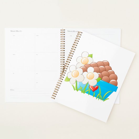 Eieren in blauwe kom met bloemen en hart planner
