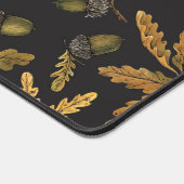 Eikels en eikenbladeren op zwart bureaumat (Hoek)