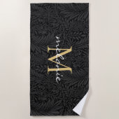 Elegant zwart gouden bloemenscript monogram strandlaken (Voorkant)