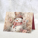Elegante Bloemen Sneeuwman Kerstmis Feestdagen Kaart<br><div class="desc">Een chique stijl waterverf roze bloemen kerst sneeuwpop gevouwen vakantie kaart. Voorzien van een boodschap en naam aan de binnenkant. Personaliseer dit met uw eigen vakantie begroetingsbericht en familienaam! Dit is een mooie en unieke kaart om naar je vrienden en familie te sturen voor de feestdagen.</div>