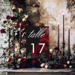 Elegante Moody Bloed Rode Rozen Bloemen Kaart<br><div class="desc">Omarm tijdloze elegantie voor uw gotische geïnspireerde feest met onze boeiende trouwtafel nummer kaart. Een zachte zwarte achtergrond biedt het perfecte canvas voor een boeiend, maar ingetogen boeket. Stel je een arrangement van gedempte bloed rode roos bloeit, waar rijke rode tinten vermengen met donkergroen gebladerte. Dit etherische ontwerp straalt rustige...</div>
