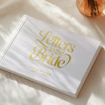 Elegante witte en gouden brieven aan de bruid gastenboek<br><div class="desc">Elegante witte en gouden brieven aan de bruid Folie gastenboek koester uw huwelijksherinneringen voor altijd met dit prachtige souvenir boek. · Luxe witte en gouden folie ontwerp voegt een vleugje elegantie toe aan uw speciale dag · Perfect voor het verzamelen van oprechte berichten van bruidsmeisjes, familie en vrienden · Veelzijdig...</div>