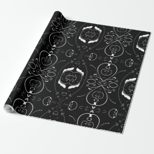 Elegante witte krullen en versieringen op zwart cadeaupapier