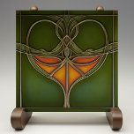 Emerald Grace Art Nouveau Tegeltje<br><div class="desc">Verwen uw huis met de tijdloze elegantie van de "Emerald Grace Art Nouveau Ceramic Tegel", een prachtig stuk dat de vloeibaarheid en biologische schoonheid van de Art Nouveau-beweging belichaamt. Deze keramische tegel, bedrukt door Zazzle, heeft een boeiend ontwerp met vloeiende lijnen en een centraal motief in rijke tinten van sinaasappel...</div>