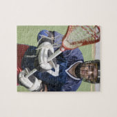 Ernstige lacrosse speler die kruis vasthoudt legpuzzel (Horizontaal)