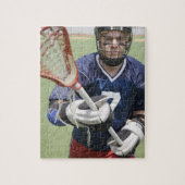 Ernstige lacrosse speler die kruis vasthoudt legpuzzel (Verticaal)