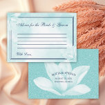 Etheral Crystal Blue Magnolia , Wedding Advieskaart<br><div class="desc">Wedding Advice Kaart met een delicate kristalblauwe magnoliumbloem boven een abstracte florale achtergrond in dezelfde tint, samen met de titel: "Advice for the Bride and Groom" in een elegant kalligrafiescript, omringd door twee dunne randen. Op de achterzijde staan uw namen, datum, plaats en staat op een faux glitter achtergrond en...</div>