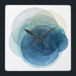 Evolving Planets - Waterverf cirkels Vierkante Klok<br><div class="desc">Evolving Planeten I door Grace Popp. Waterverf cirkels creëer planeet-achtige vormen die elkaar overlappen om prachtige variaties van blauw en blauwgroen te onthullen.</div>