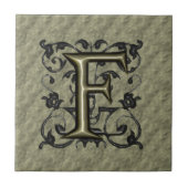 F -  monogram in reliëfdruk (goud) tegeltje (Voorkant)