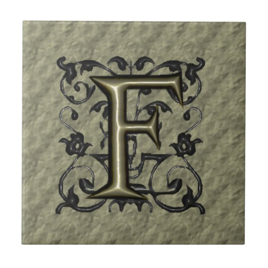 F -  monogram in reliëfdruk (goud) tegeltje (Voorkant)