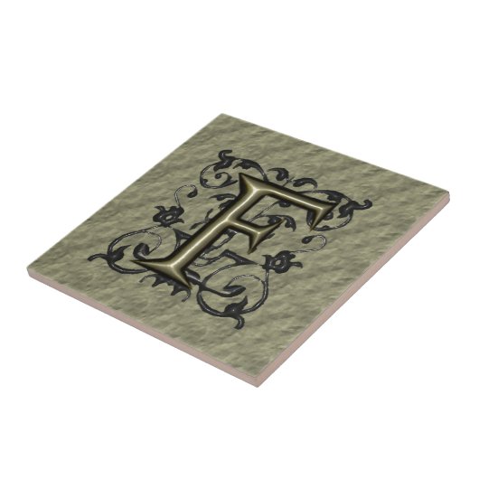 F -  monogram in reliëfdruk (goud) tegeltje (Zijkant)