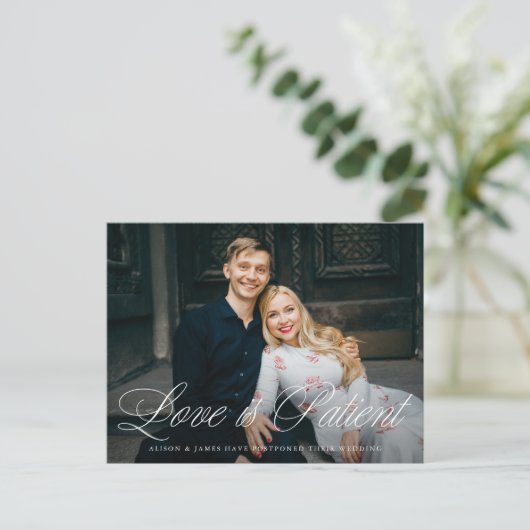 Fancy Script Love is Patient Wedding Postponement Aankondigingskaart (Staand voorkant)