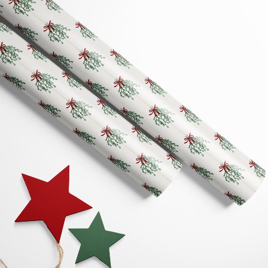 Feestelijke maretak met rode strikken cadeaupapier