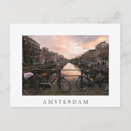 Fietsen op zonsondergang in Amsterdam Briefkaart