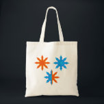 Fire and Ice Eight Point Stars Tote Bag<br><div class="desc">Carry your essentials in style with this fire and ice eight point star tote bag. This versatile reusable bag features a vibrant symmetrical graphic of orange flames and blue water petals that stands out in any crowd. The high contrast celestial starburst design makes it a fashionable accessory for shopping trips,...</div>