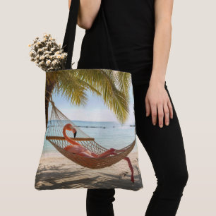 Flamingo die luiert in een tropische strandhangmat tote bag