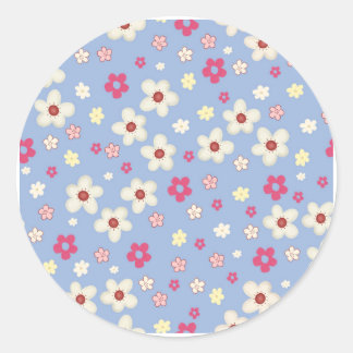 fleurs printanières sur fond bleu ronde sticker