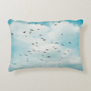 Flock of grey dove fly on vintage blue sky. above accent kussen