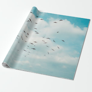 Flock of grey dove fly on vintage blue sky. above cadeaupapier