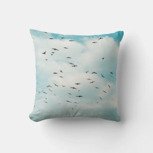 Flock of grey dove fly on vintage blue sky. above kussen