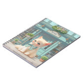 Fluffy kitten met blauwe boog bij banketbakkerij notitieboek (Linkerzijde)