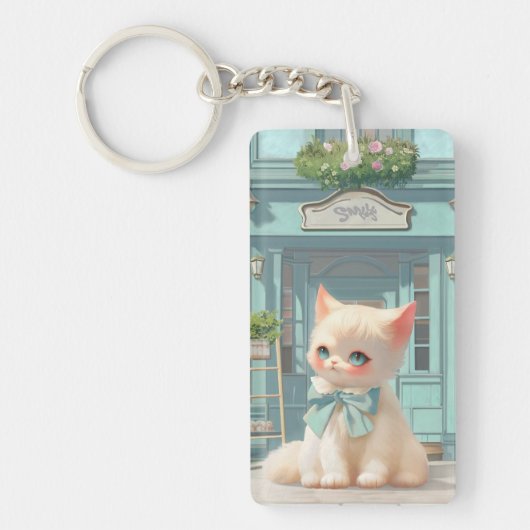 Fluffy kitten met blauwe boog bij banketbakkerij sleutelhanger (Voorkant)