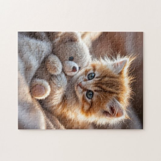Fluffy red kitten playing with a tiny teddy bear,  legpuzzel (Horizontaal)