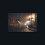 Foggy Victorian Cobblestone Alley Glow Canvas Afdruk<br><div class="desc">Thick fog envelops a narrow Victorian cobblestone alley lit by warm amber street lamps mounted on elegant wrought-iron brackets. Tall Georgian brick buildings with tall windows rise on both sides, their details softened by the mist that turns every light into a glowing halo. The curving lane fades into impenetrable darkness,...</div>