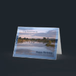 Foster Son, meer bij zonsopgang Birthday kaart<br><div class="desc">Een prachtige foto van een uitzicht van een meer bij zonsopgang met wolken die in het water reflecteren. Een geweldige manier om iemand een Happy Birthday toe te wensen. Copyright Norma Cornes.</div>
