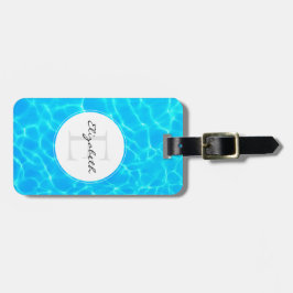 Foto met weerspiegelingen in glinsterend blauwe zw bagagelabel