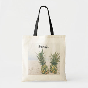 Foto van 2 ananassen op een strand tote bag