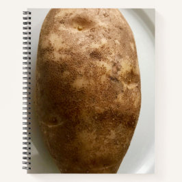 Foto van een bruine aardappel op een witte bord notitieboek