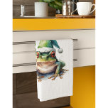 Frolic Christmas Frog, op maat Theedoek<br><div class="desc">Breng een vleugje feestelijke charme naar uw keuken met onze schattige "Frolic Christmas Frog" aanpasbare keukenhanddoek! Dit prachtige ontwerp is voorzien van een vreugdevolle waterverf groene boomkikker, vrolijk versierd in een feestelijke groene kerstmuts, klaar om in uw vakantie te springen koken en bakken. Het is de perfecte manier om een...</div>