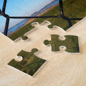 Fubby poppetje dat in het hek omhoog klimt. legpuzzel (Zijkant)