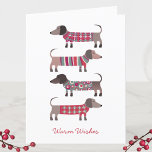 Fun Dachshund Dog Feestdagen Kaart<br><div class="desc">Schattige kleine Dachshund,  Wiener of SaUSE Dogs in lui winterbreiwerk. Verander de groet op de voorzijde en de binnenkant en ook de namen om te personaliseren. Originele kunst van Nic Squirrell.</div>