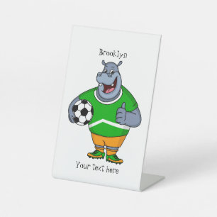 Funny hippo soccer player cartoon reclamebord met voetstuk