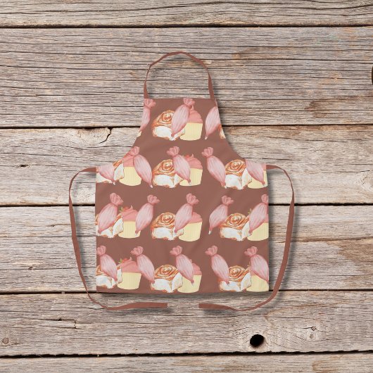 Gebakszakken, kaneelbroodjes en bruine cupcakes schort